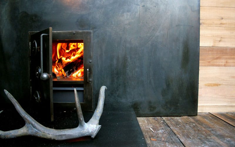 Wood stove inside shipping container sauna