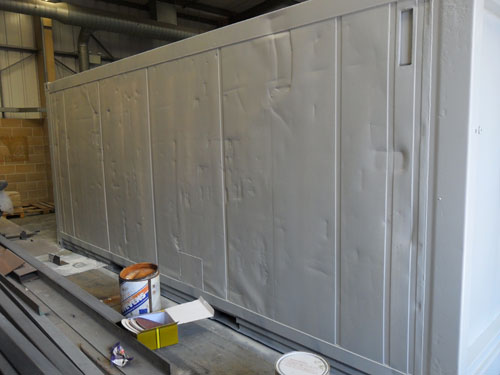 shipping container shot-blasting and primer application shipping container conversion beer cellar